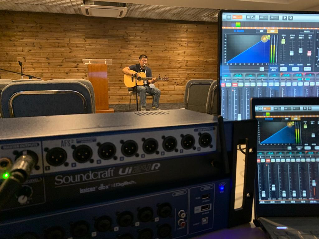A man recording his audio with the respective equipment