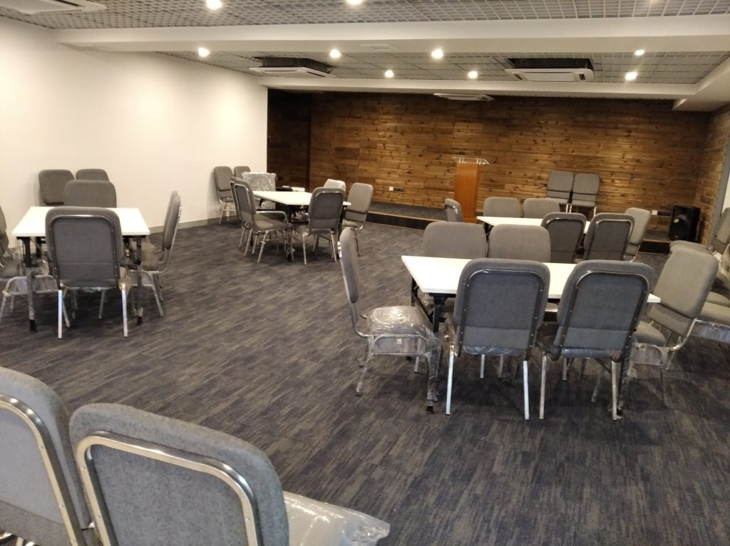 A conference hall is ready for a meeting with all arrangements