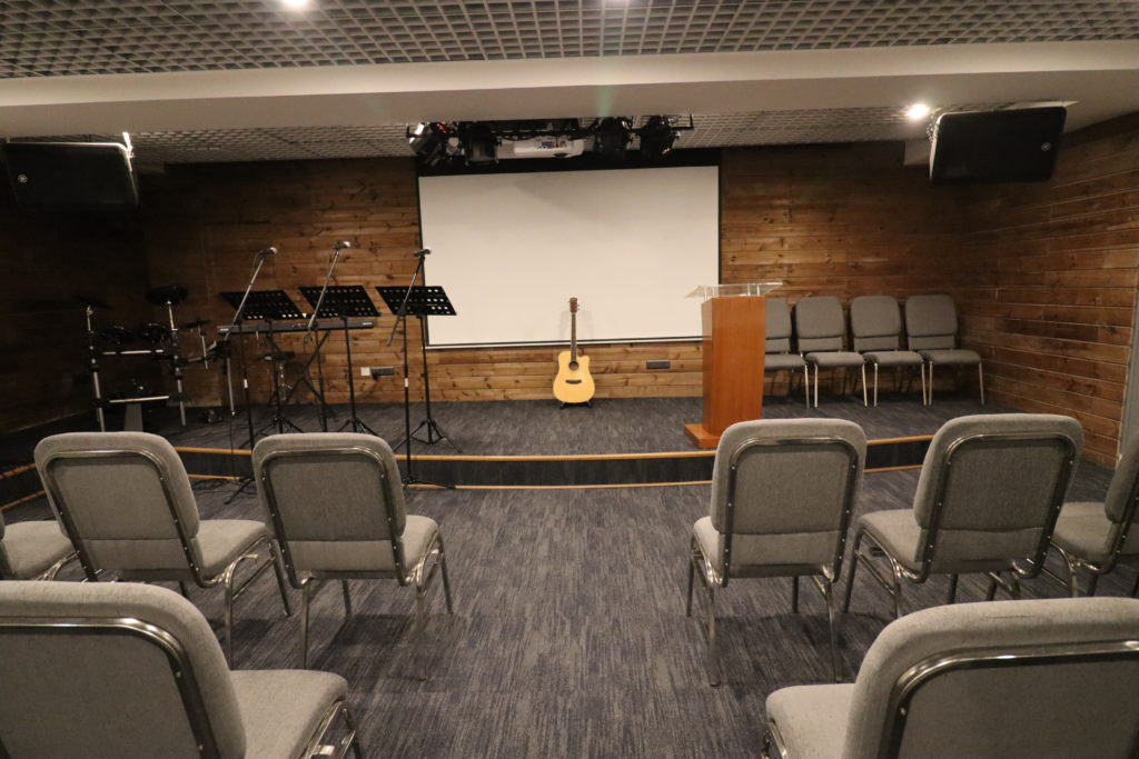 An audience view of an auditorium stage